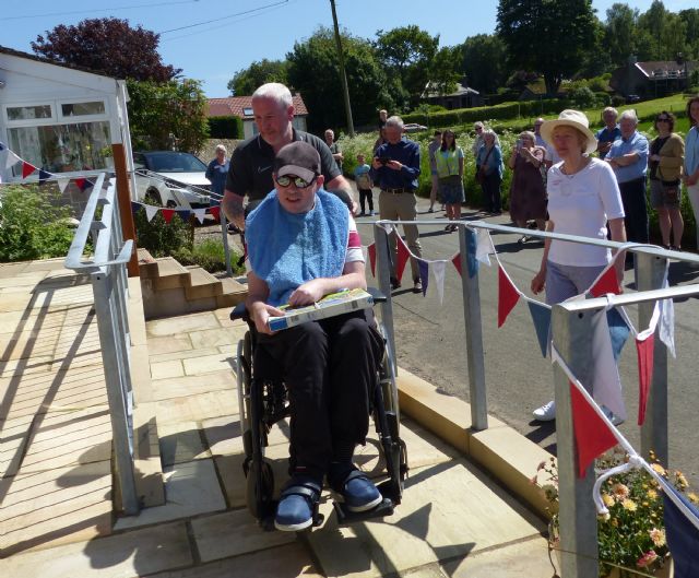 Matthew Peachey taking the first official journey up the ramp to the refurbished Village Hall Matthew Peachey taking the first official journey up the ramp to the refurbished Village Hall